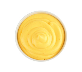 Bowl with cheese sauce on white background