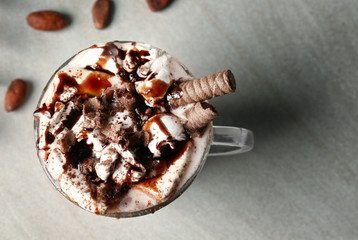 Cup of tasty cocoa drink with marshmallow on table