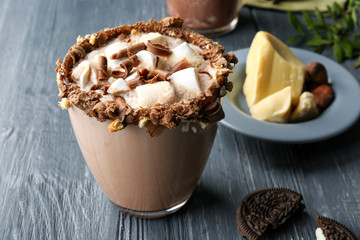 Cup of tasty cocoa drink with marshmallow on wooden table