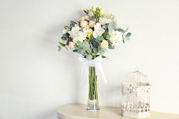 Beautiful bouquet with freesia flowers in vase on table