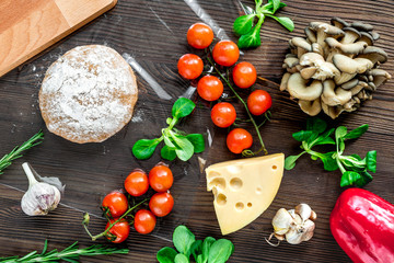 restaurant kitchen with pizza preparing on wooden background top view