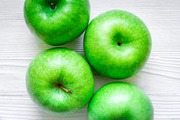 ripe green apples white table background
