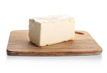 Board with butter on white background, closeup