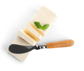 Delicious butter pieces with shovel and  basil leaves on white background, closeup
