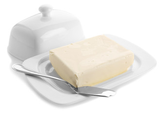 Dish with butter and shovel on white background