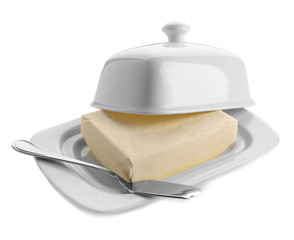 Dish with butter and shovel on white background