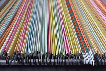 Financial document files arranged in filing cabinets.
