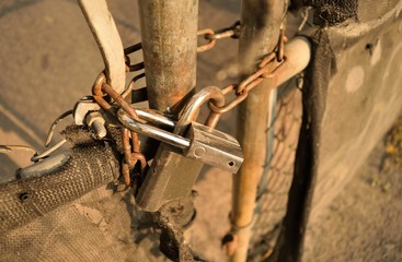 A chained fence gate held together by two locks