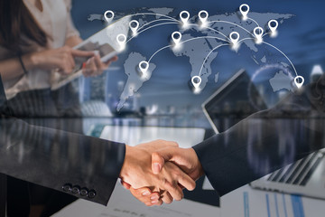 Double exposure of business people handshake greeting deal concept on blue tone of cityscape business district background with map pin flat network conection on world global cartography globalization.