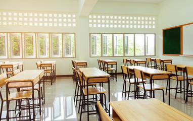 School classroom with desks chair wood, and blackboard in high school thailand, vintage tone education concept