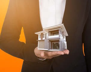 house in business hand with sunlight