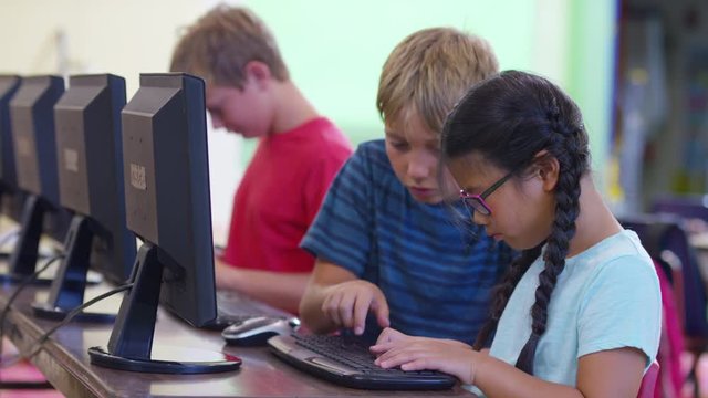 Students in school classroom using computers