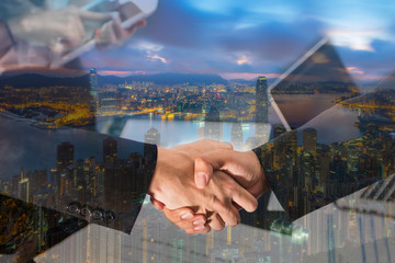 Double Exposure of a businessman handshake on Aerial view of Hong Kong at night
