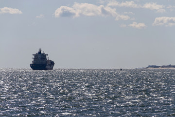 Tug Boat and Large Ship Together Near Land