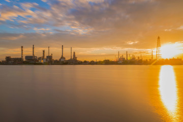 Oil refinery or petroleum refinery industrial process plant with sunrise, oil refineries use much of the technology, as types of chemical plants, the downstream side of the petroleum industry.