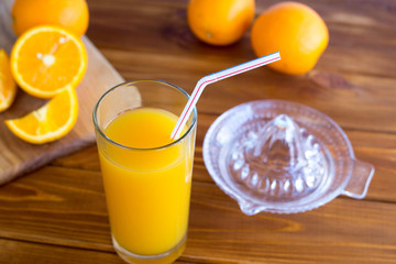 Preparing fresh orange juice squeezed with juicer on a white background