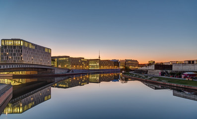 Office buildings at the river Spree in Berlin at dawn with the Television tower in the back