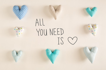 All You Need Is Love message with blue heart cushions