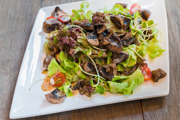 Spicy salad with mushrooms, arugula and sesame. Vegan dish.