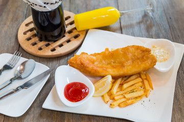 Traditional English food - Fish and chips with ketchup and lemon