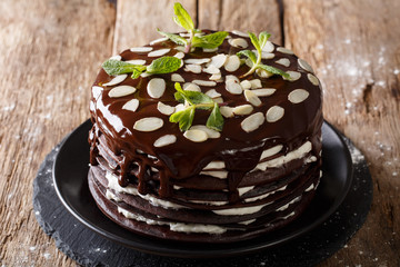 Beautiful chocolate crepes with whipped cream cake decorated with almonds