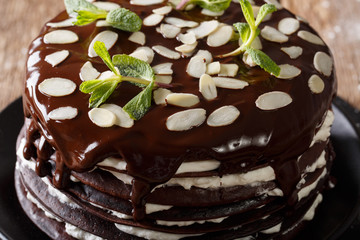 Chocolate crepes cake with whipped cream and almonds macro. horizontal