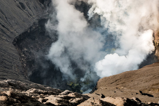 Crater of Bromo volcano (gunung) close-up with erupting smoke in Bromo Tengger Semeru National Park, East Java, Indonesia