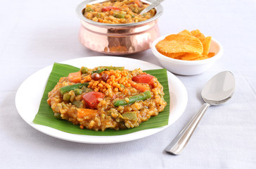 South Indian traditional and popular vegetarian rice dish, bisi bele bath, which has rice, vegetables and pigeon pea as the main ingredients.