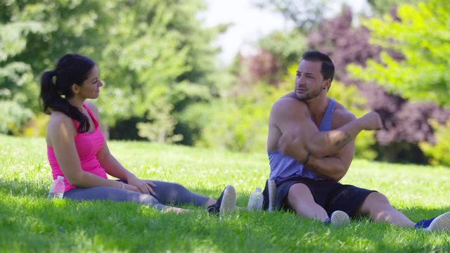 Athletic couple at park stretching before run