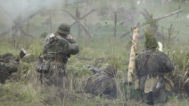  Historical reconstruction of Second World War. Soldiers on battle field during  assault on Fort 5 in Koenigsberg. hostilities of  Second World war. Slow Motion.