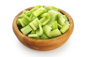 Fresh sliced celery in a wooden bowl isolated on white background.