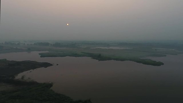Aerial View. Panoramic summer morning landscape. The picturesque landscape with river, trees and field with Incredible sun. Morning Fog.