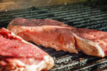 bbq beef steaks on hot grill