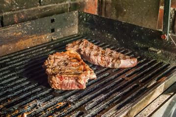 bbq beef steaks on hot grill