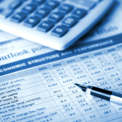 calculator and pen on financial report