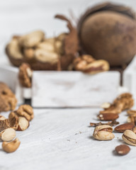 different nuts closeup on white wooden background