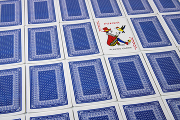 A joker among overturned playing cards facing upwards