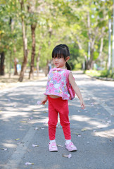 Portrait of cute little girl in the public park with looking straight and posture