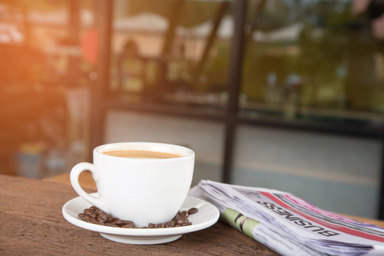 A cup of coffee and a newspaper