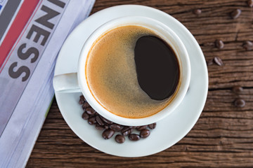 A cup of coffee and a newspaper