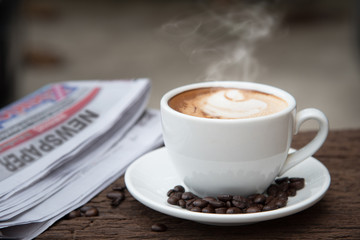A cup of coffee and a newspaper