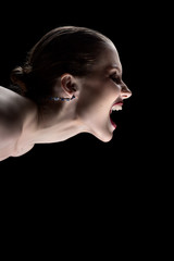 angry nude girl screaming on black background