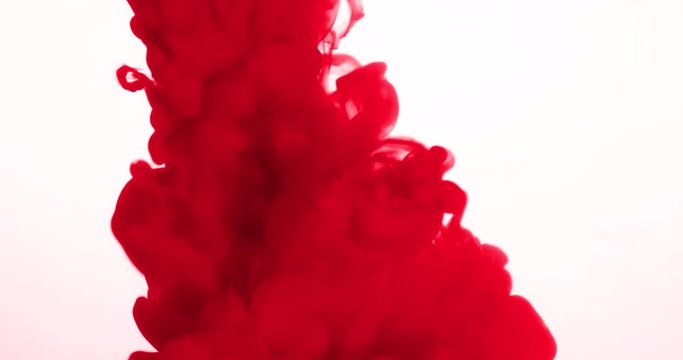 abstract red ink in water on white background, slow motion