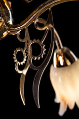 Chandelier light in interior closeup on black background
