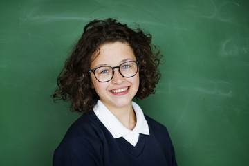 A girl student in front of a blackboard