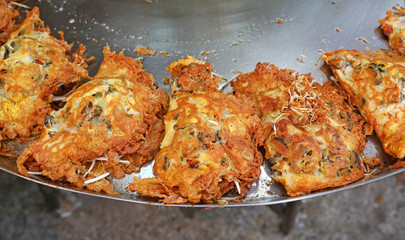 Delicious crispy shellfish fried on pan.