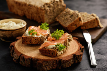 Homemade bread and sandwiches with salmon and cheese.