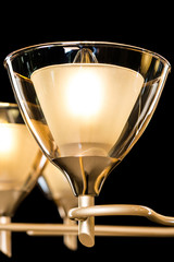 Chandelier light in interior closeup on black background