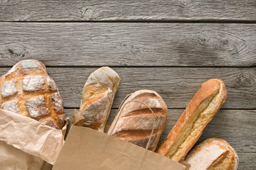 Bread bakery background. Brown and white wheat grain loaves composition on rustic wood