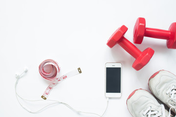 Flat lay of smartphone with measuring tape, red dumbbells and sport shoes on white background with copy space, Healthy lifestyle and diet concept